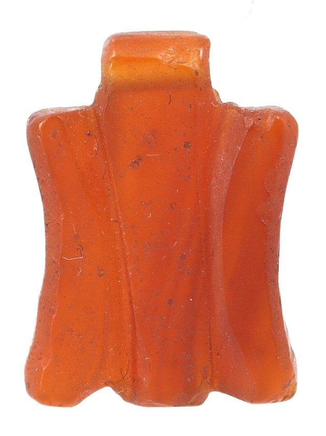 An Ancient Southeast Asian Carnelian Agate Amulet, 1st Millennium BCE: Behold this small yet captivating carnelian agate amulet, a mere 1.9 by 1.4 cm in dimension. Originating from Southeast Asia and dating back to the 1st millennium BCE, this amulet embodies the essence