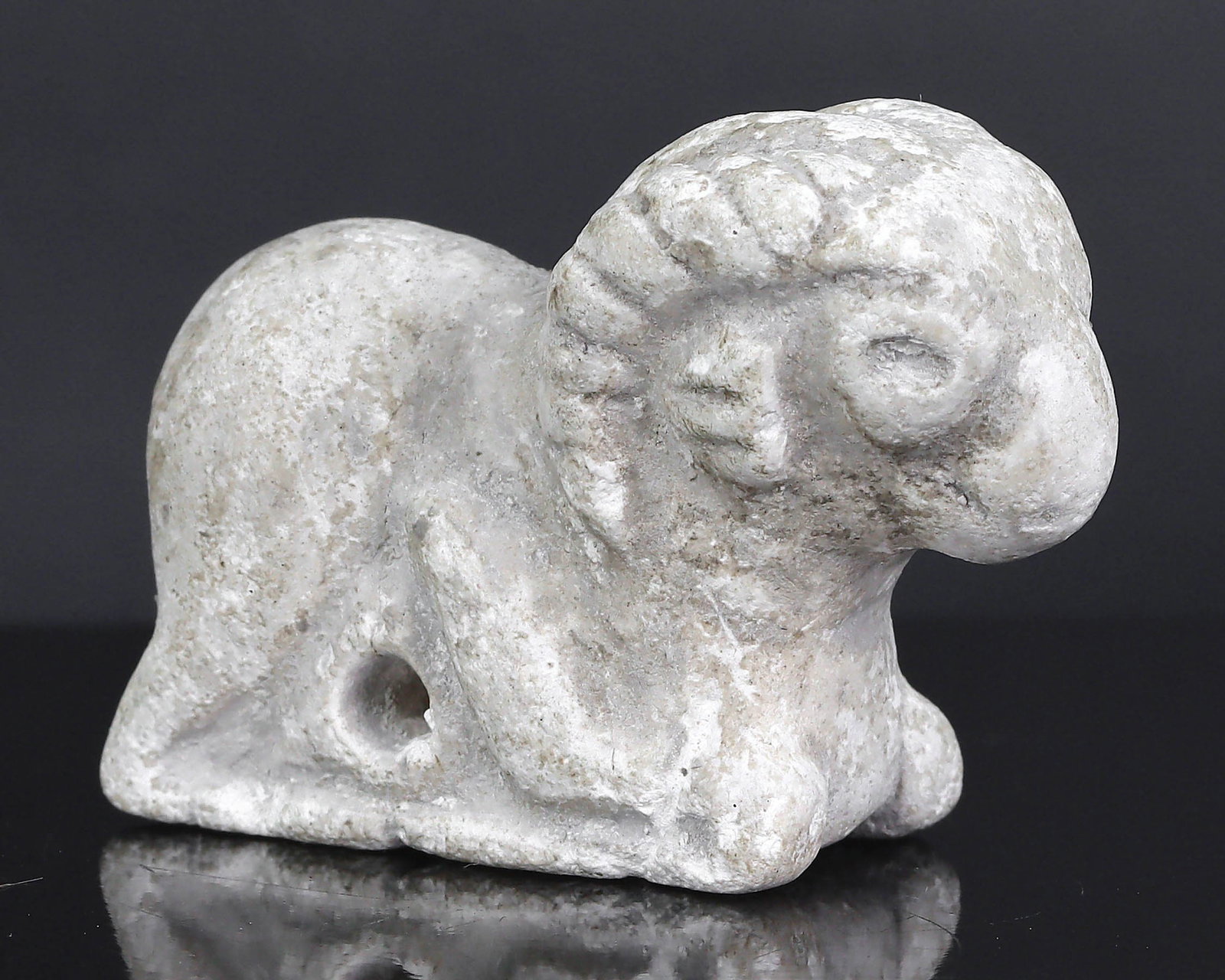 An Ancient Near Eastern Alabaster Ram Amulet, Circa 2nd Millennium BCE: This meticulously sculpted alabaster ram, an emblem of strength and leadership, hails from the ancient Near Eastern region. Rams were frequently depicted in the art and mythology of the area, symboliz