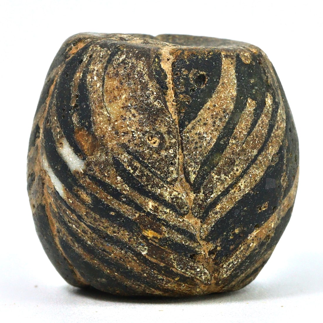 An Ancient Islamic Chevron Lining Glass Bead, Circa 9th-11th Century CE: This glass bead, featuring the distinctive chevron pattern, is indicative of Islamic art from the 9th to the 11th century CE. Chevron beads were crafted using a multi-layered glass technique, highly p