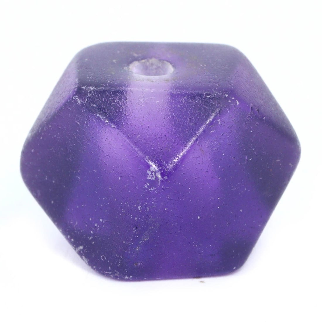 An Antique Mughal Empire Carved Amethyst Bead, c. 16th-18th Century: This regal amethyst bead, expertly carved and polished, is reminiscent of the opulent Mughal era, when such gemstones were favored in royal jewelry. The bead’s faceted surfaces reflect the Mughals' 