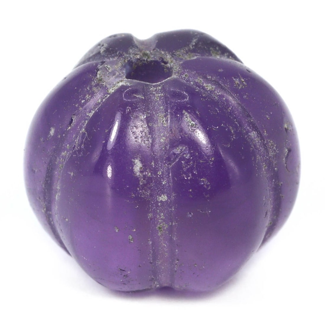 An Antique Mughal Empire Melon-Shaped Amethyst Bead, 16th–19th Century: A distinct South Asian melon-shaped amethyst bead, with a polished surface that accentuates its deep purple hues and natural inclusions. The ribbed melon shape is indicative of the skilled craftsmansh