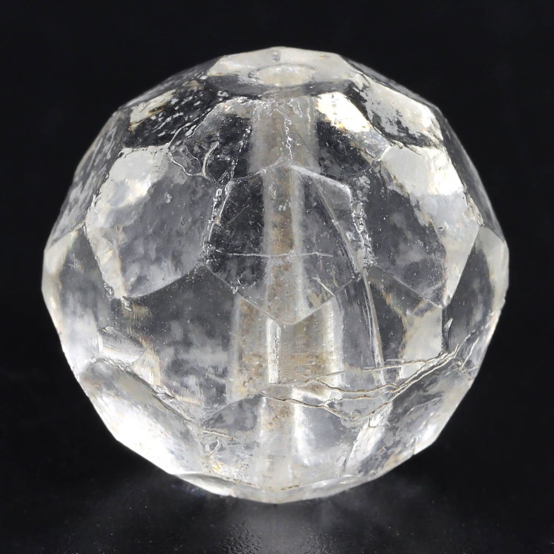 An Antique Bohemian Crystal Bead, 18th-19th Century: This exquisite antique crystal bead from Bohemia reflects the region's storied tradition of glassmaking. Crafted in the 18th to 19th century, this bead showcases the exceptional clarity and skillful f