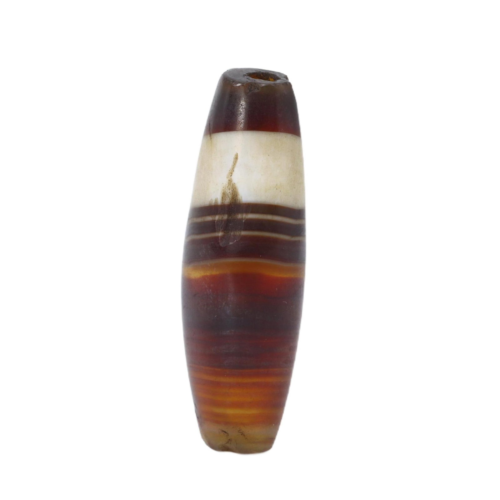 An Antique Silk Road Era Tibetan Dzi Bead, 11th-16th Century: This Dzi bead, marked by its length and the wavy, flowing bands reminiscent of the agate's natural layering, speaks to its origin along the ancient Silk Road. Prized for millennia, Dzi beads are rever
