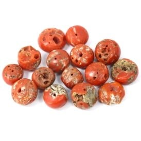 A Group of Antique Tibetan Coral Mala Beads, 18th-19th Century CE: This collection of antique Tibetan mala beads is composed of red coral, a material historically prized for its rich color and believed to have protective properties. Such beads were integral to the pr