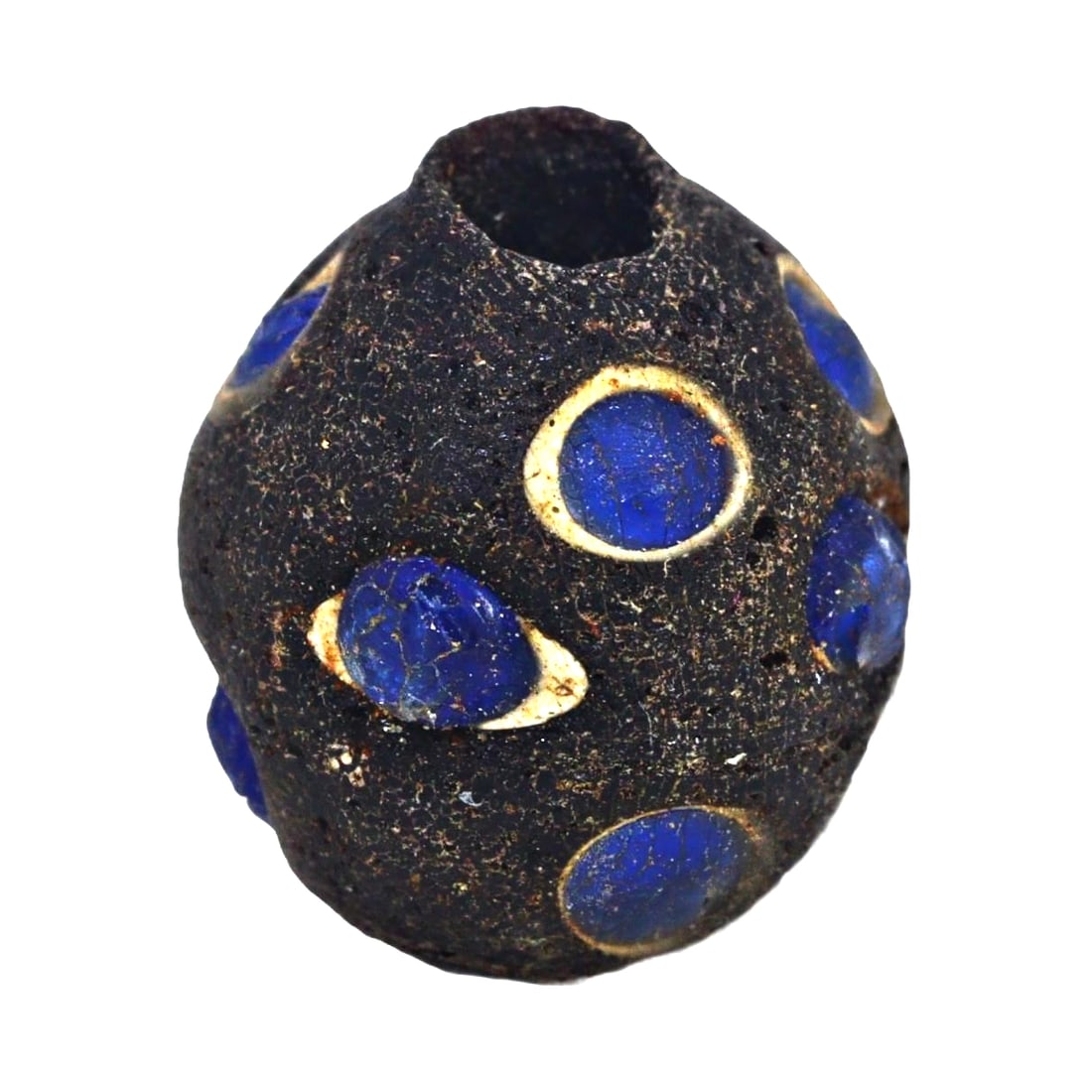An Ancient Roman Eye Bead in Lapis Lazuli, ca. 1st-3rd Century CE: Category: Beads and Jewelry Components This ancient Roman eye bead, crafted from lapis lazuli color glass and embedded in a black matrix, represents a protective talisman of the era. The use of the 'e