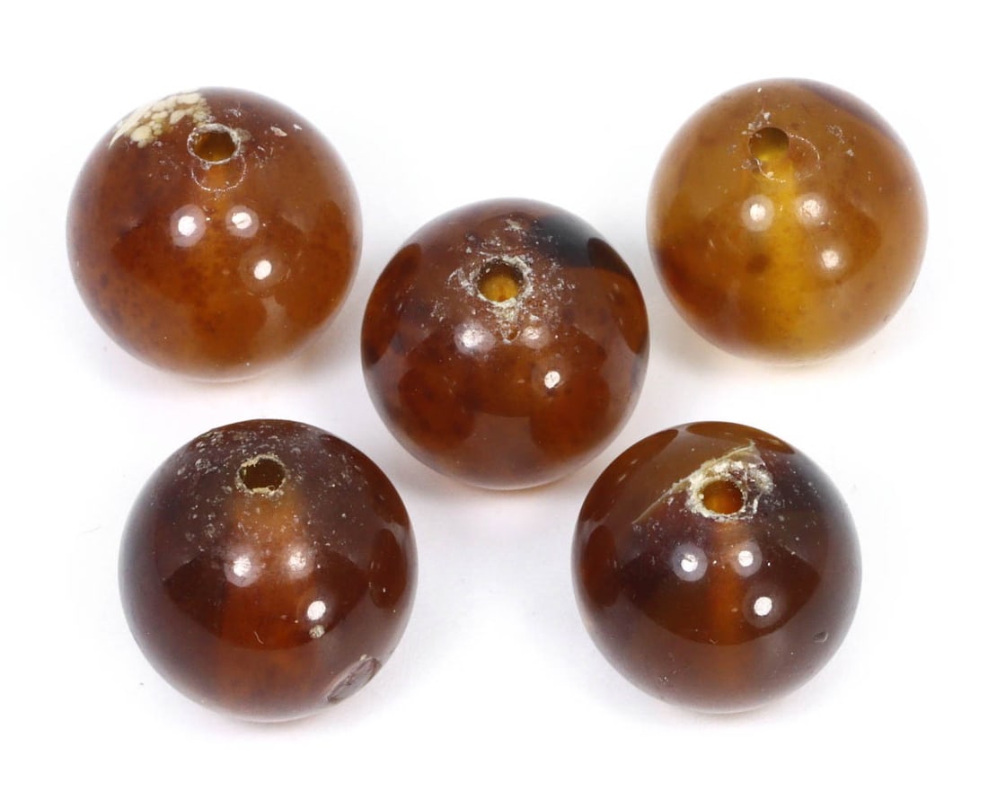 A Lot of Mid-Century Tibetan Amber Round Beads, c. 1950s: Category: Beads and Jewelry Components This mid-20th century Tibetan amber bead, with its deep honey hue and translucent quality, reflects the rich tradition of using natural materials in Tibetan cult
