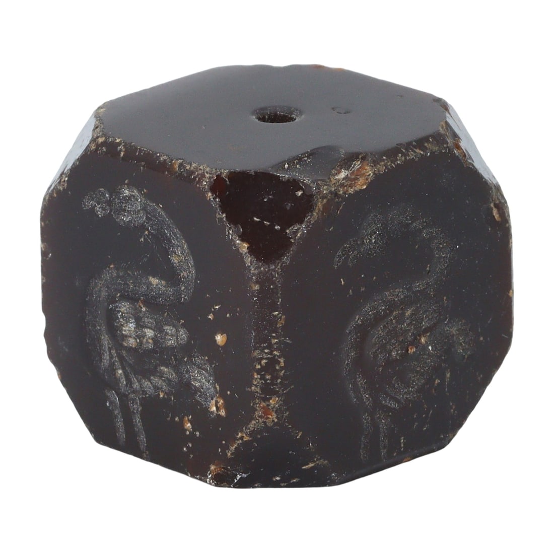 An Antique of Medieval Islamic Period Egyptian Stone Bead, 9th-12th Century: This stone bead from Egypt, dating to the 9th–12th century, embodies the medieval Islamic period's artistic expression. Its dark surface is etched with motifs that may have held significance in the