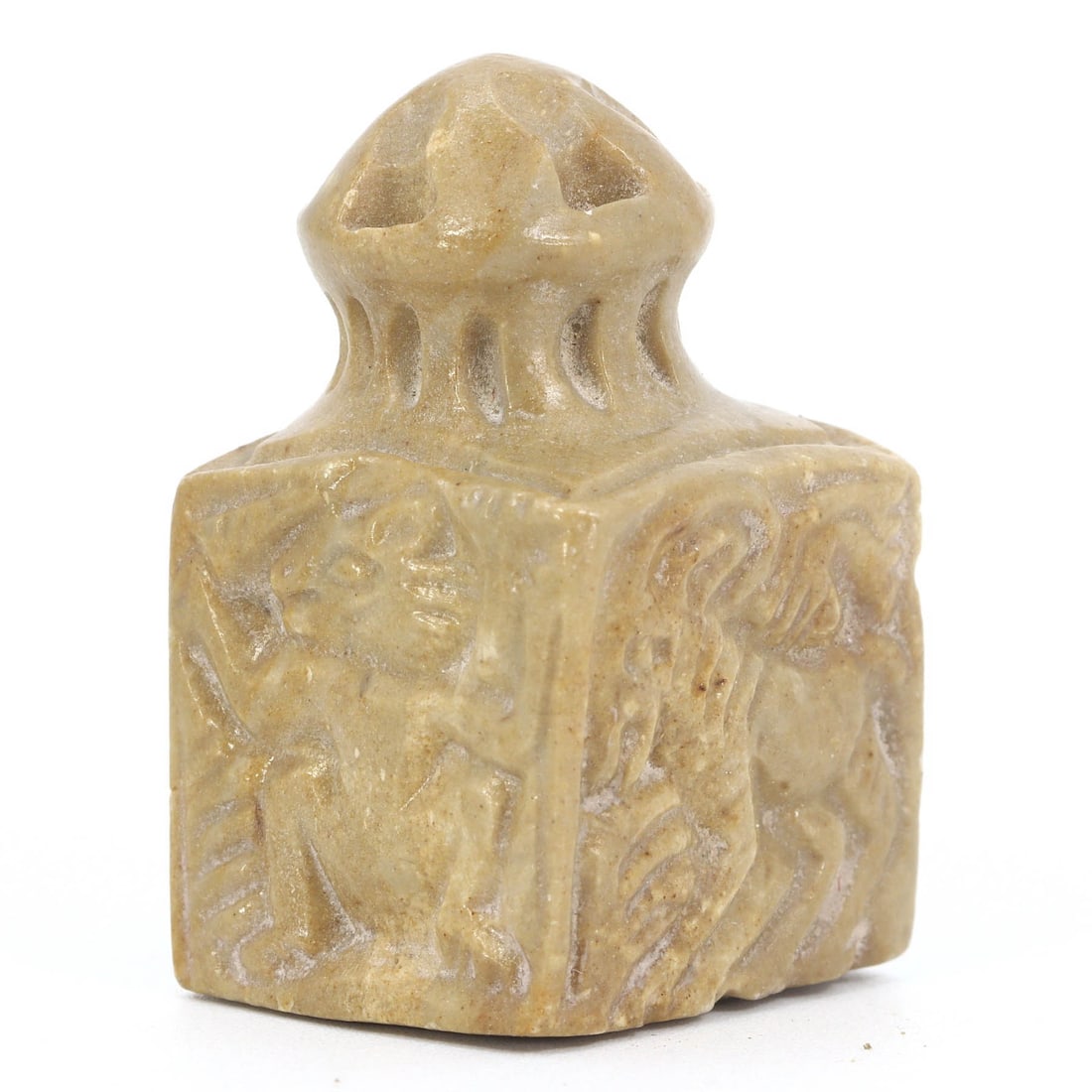 Ancient Byzantine Limestone Stamp Seal with Humanoid Face, ca. 4th-7th Century AD: This Byzantine-era limestone seal features a stylized humanoid face, indicative of the era's iconographic symbolism. As a personal seal, it served as a mark of identity and authority, often pressing i