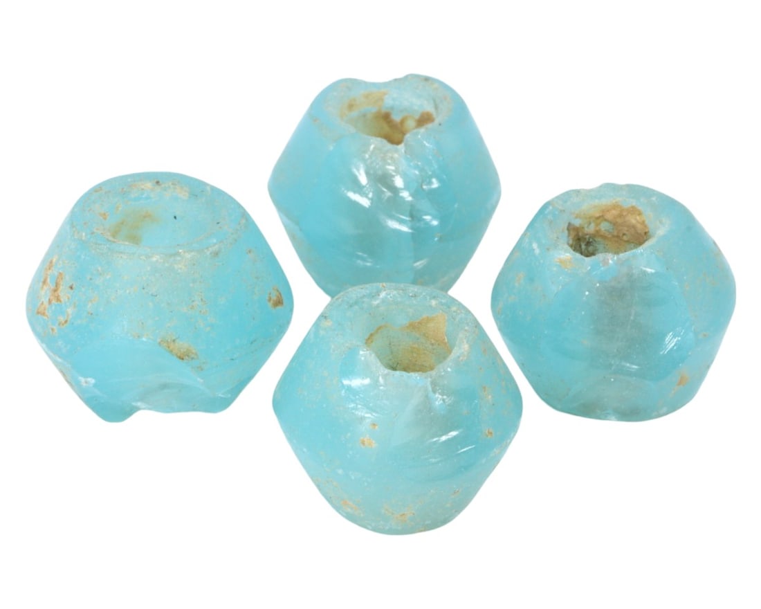 Lot of 4 Antique Islamic Period Paraiba-Colored Glass Beads, c. 10th-15th Century: This lot of four vibrant paraiba-colored glass beads, each measuring approximately 2 cm, likely originates from the Islamic period, spanning from the 10th to the 15th century. The distinct color and f