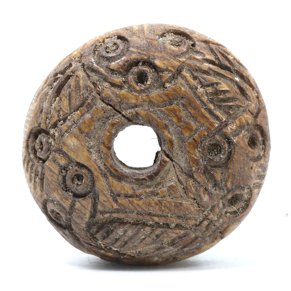 Ancient Samanid Era Incised Bone Bead, 9th-10th Century, Excavated in Nishapur, Iran: Originating from the historic city of Nishapur, this incised bone bead is a relic from the Samanid Empire, reflecting the era's artistic ingenuity. The meticulous carvings illustrate the period's soph