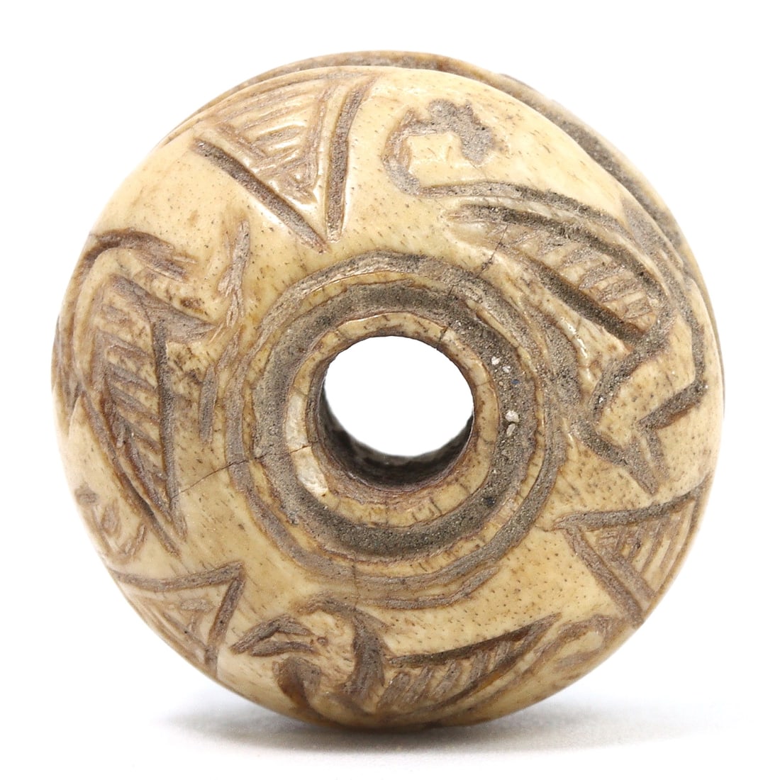 Ancient Samanid Era Incised Bone Bead, 9th-10th Century, Excavated in Nishapur, Iran: Originating from the historic city of Nishapur, this incised bone bead is a relic from the Samanid Empire, reflecting the era's artistic ingenuity. The meticulous carvings illustrate the period's soph