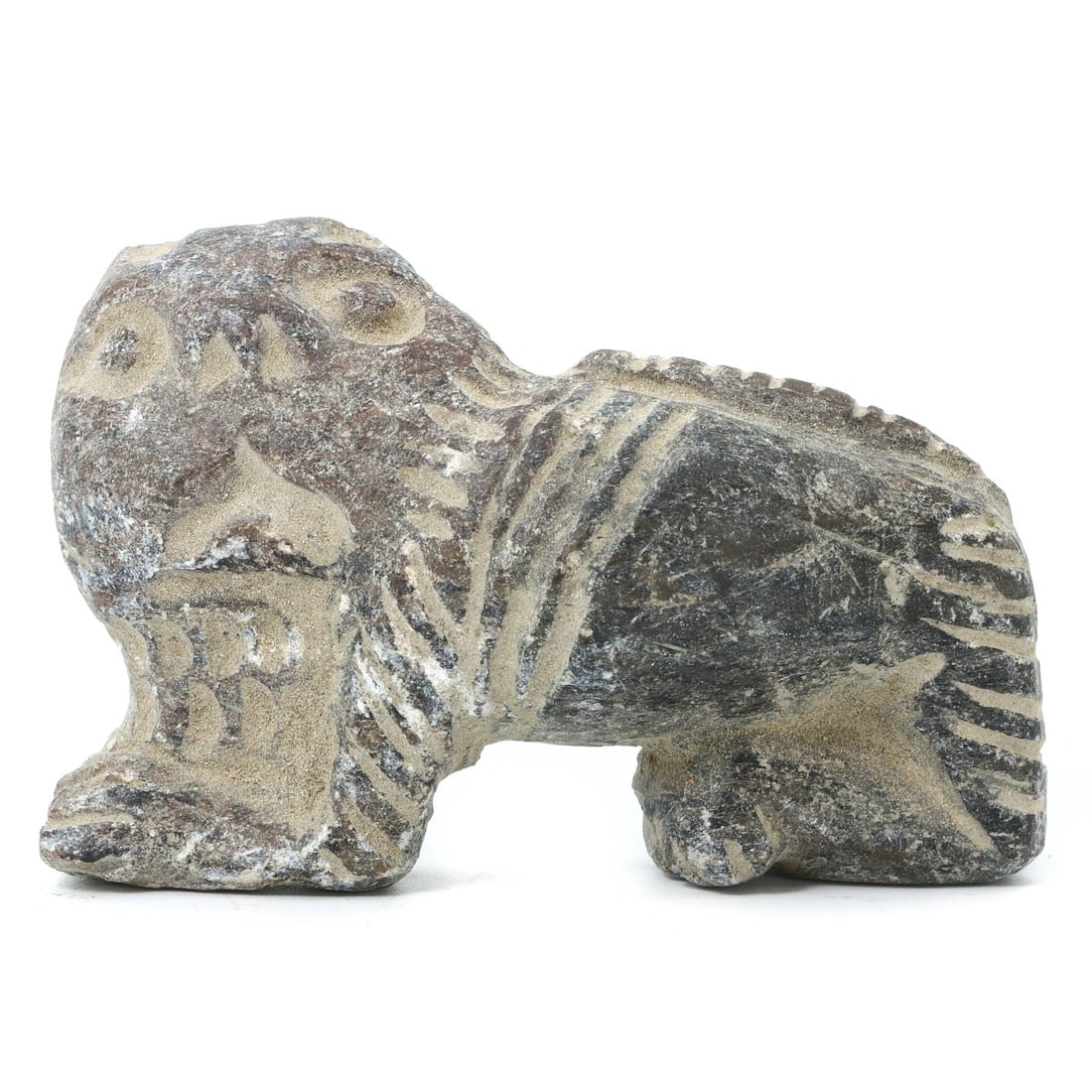 An Ancient Mesopotamian Stone Lion Amulet, Circa 2nd Millennium BCE: This stone amulet, intricately carved in the form of a lion, symbolizes the power and majesty that the animal represented in ancient Mesopotamia. The lion was often associated with royalty and divine