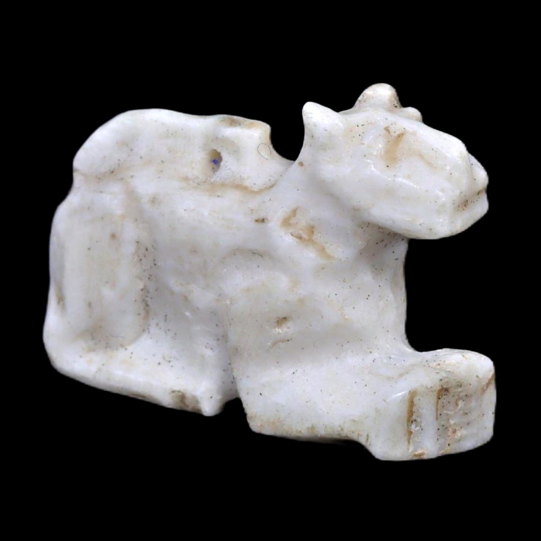 An Ancient Near Eastern Bone Carving of a Canine, c. 2nd Millennium BCE: Category: Figurines and Statuettes This bone carving represents a canine figure, possibly linked to either Egyptian or Mesopotamian cultures. Artifacts like this may have served as amulets or were par