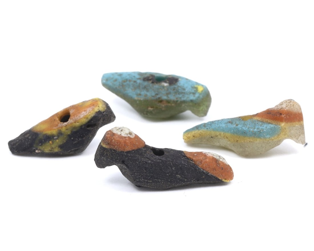 A Collection of Four Ancient Roman-Byzantine Glass Bird Form Beads, c. 1st-5th Century CE: These four glass beads, shaped like birds and dating from the Roman to Byzantine periods, demonstrate the continuity and evolution of glassworking techniques over several centuries. The vibrant colors