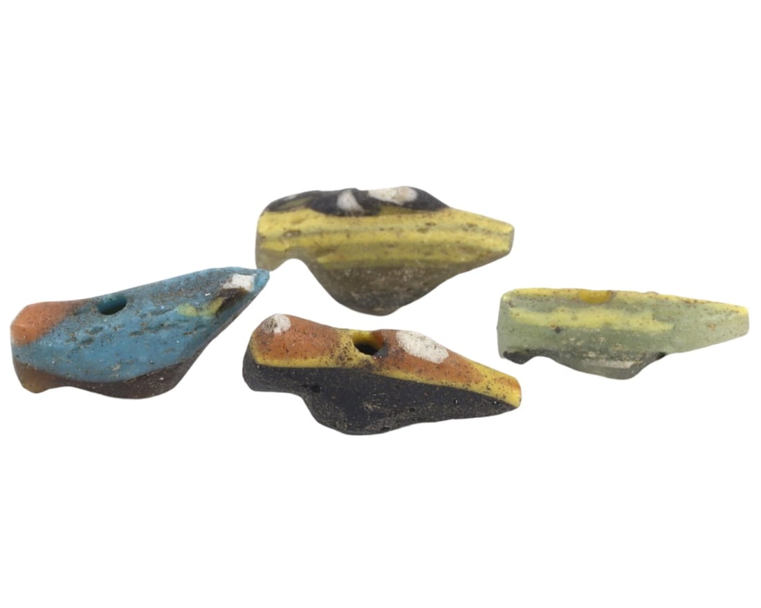 A Collection of Four Ancient Roman-Byzantine Glass Bird Form Beads, c. 1st-5th Century CE: These four glass beads, shaped like birds and dating from the Roman to Byzantine periods, demonstrate the continuity and evolution of glassworking techniques over several centuries. The vibrant colors