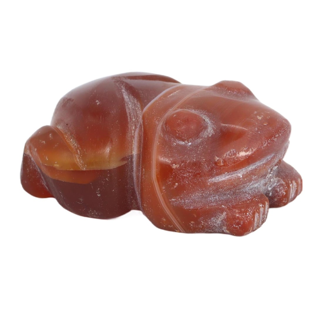 An Antique Coptic Egyptian Carnelian Frog Amulet,1st to 6th centuries AD.: This antique Coptic Egyptian amulet, intricately carved into the shape of a frog from carnelian, symbolizes fertility and renewal within the Nile region. Its vibrant red hue and smooth polish highligh