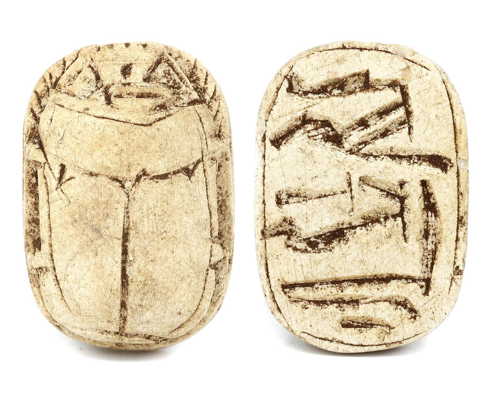 A Glazed Steatite Scarab from the Egyptian Revival, 19th Century CE: Category: Sealings This glazed steatite scarab reflects the 19th-century fascination with Ancient Egyptian culture. The intricately carved hieroglyphs and the scarab's form symbolize rebirth and regen