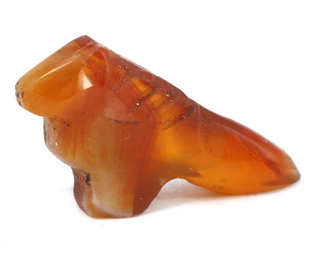An Antique Coptic Egyptian Carnelian Bird Amulet, ca. 1st-2nd Century CE: This carnelian amulet carved into the shape of a bird is a remarkable artifact from Coptic Egypt, symbolizing the soul's freedom and the afterlife's journey. The deep red tones of the carnelian enhanc