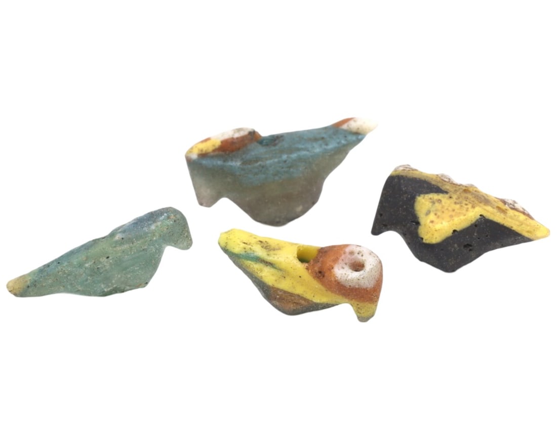 A Collection of Four Ancient Roman-Byzantine Glass Bird Form Beads, c. 1st-5th Century CE: These four glass beads, shaped like birds and dating from the Roman to Byzantine periods, demonstrate the continuity and evolution of glassworking techniques over several centuries. The vibrant colors