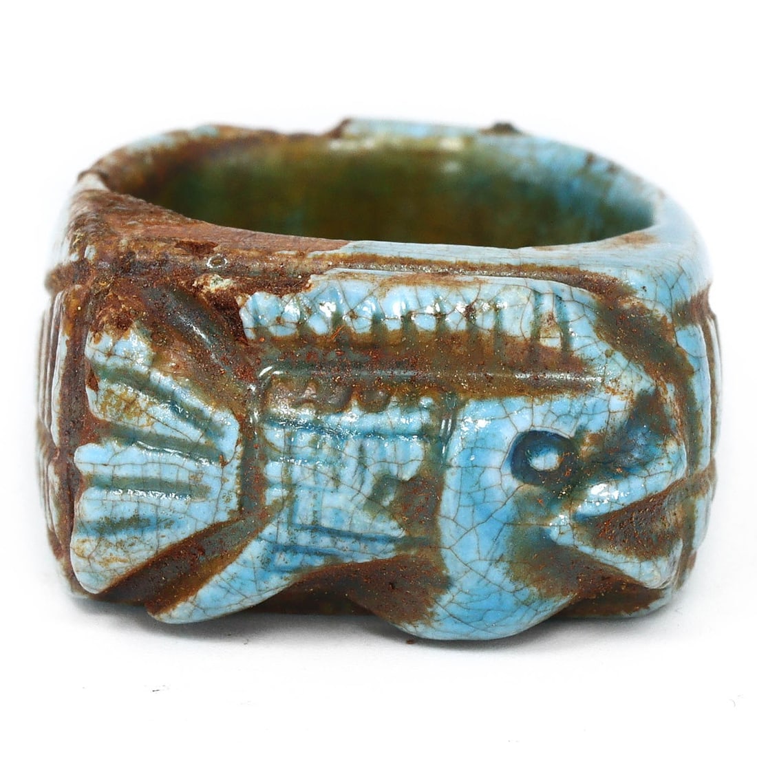 An Antique Egyptian Revival Glazed Steatite Ring, Circa 1920s: This unique ring, crafted from glazed steatite, features a prominent faience inlay depicting a crocodile, an animal revered in ancient Egypt for its power and divine protection. The deep blue glaze an