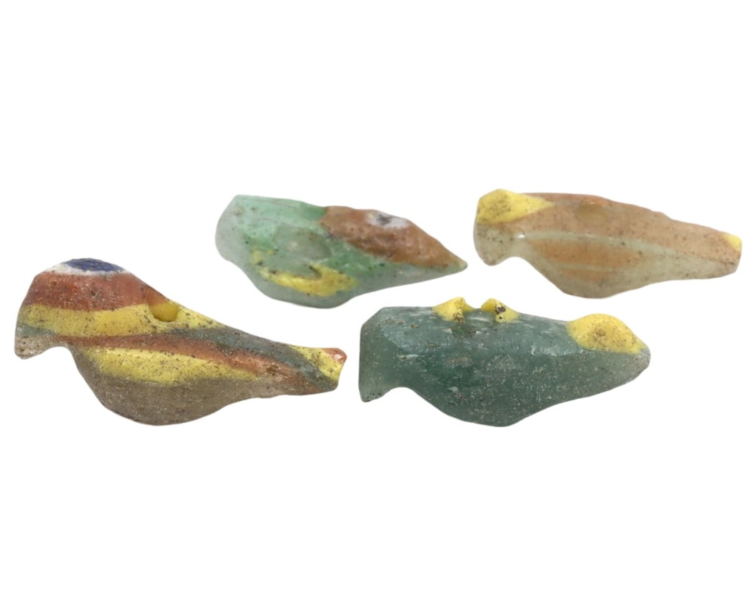 A Collection of Four Ancient Roman-Byzantine Glass Bird Form Beads, c. 1st-5th Century CE: These four glass beads, shaped like birds and dating from the Roman to Byzantine periods, demonstrate the continuity and evolution of glassworking techniques over several centuries. The vibrant colors