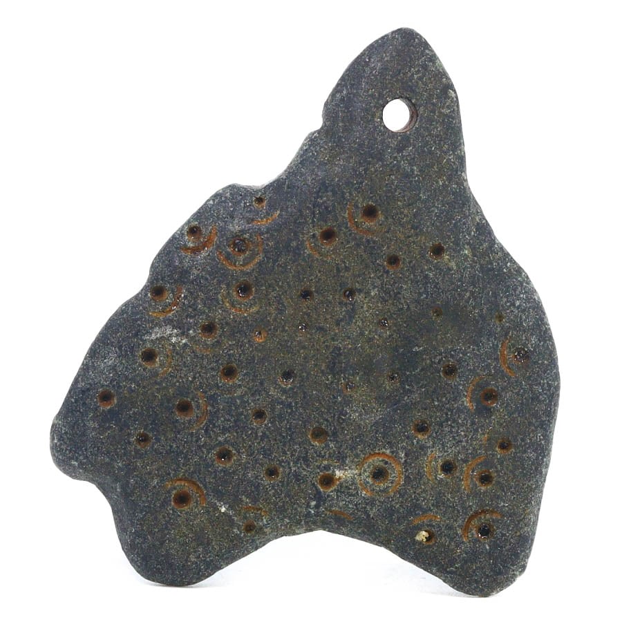 An Ancient Neo-Sumerian Steatite Amulet, c. 2112–2004 BCE: This steatite amulet from the Neo-Sumerian period, dating back to between 2112 and 2004 BCE, features intricately carved circular motifs which are characteristic of the era's symbolic art. Such amulet