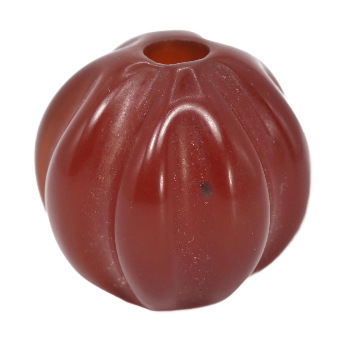 Antique Qing Dynasty Carnelian Melon-Shaped Bead, c. 1644-1912: Description:This singular carnelian bead, shaped like a melon, originates from the Qing Dynasty era, circa 1644 to 1912. Its smooth, glossy finish and deep red hue exemplify the high-quality gemstone 