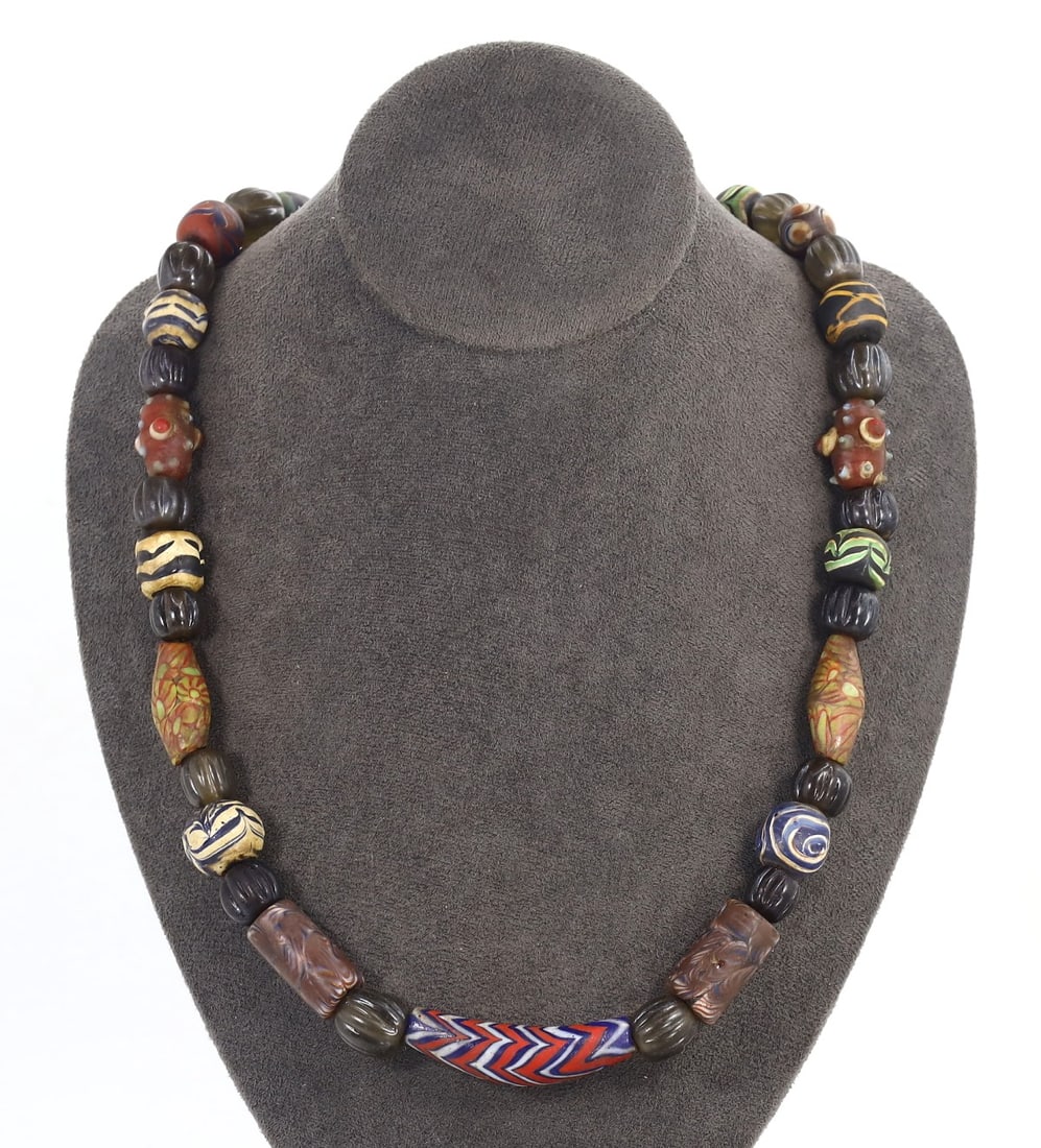 Antique Glass Bead Necklace with Millefiori, Chevron, and Murano Beads, Circa 19th-20th Century: Category: Beads and Jewelry Components This necklace is a vibrant collection of historical glasswork, featuring renowned Millefiori, Chevron, and Murano beads. Each bead encapsulates centuries of Vene