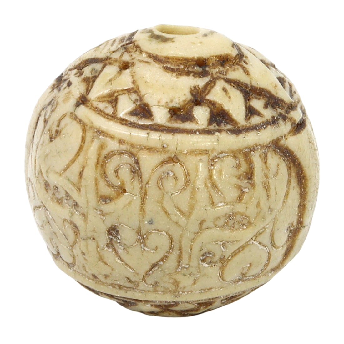 An Islamic Period Carved Bone Bead, c. 17th-18th Century CE: This intricately carved bead, made from bone, showcases the fine craftsmanship of the Islamic period, dating back to the 17th-18th century CE. The bead features detailed carvings that reflect the arti