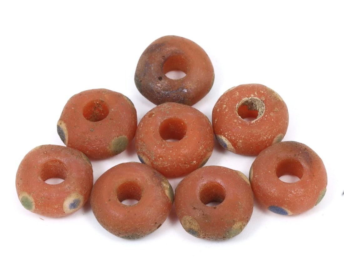 An Antique Byzantine Wound Glass Collection of Beads, c. 500-800 AD: This exquisite collection of bowl-shaped beads, made from warming peach, caramelized, and brown wound glass with mosaic glass insets. Dating back to the Byzantine period (c. 500-800 AD), it exemplifie