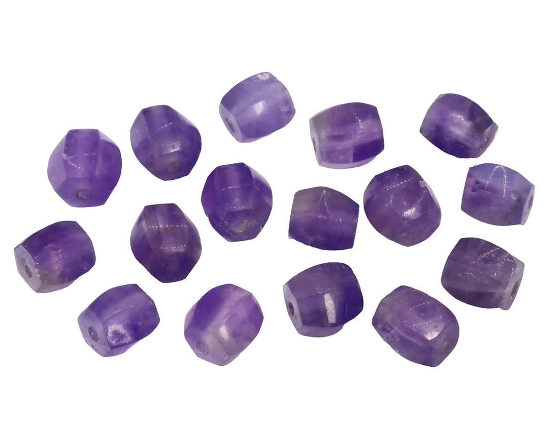 An Antique Mughal Empire Amethyst Collection of Beads, c. 1526-1857: This exquisite collection of shield-shaped beads, made from purple, daphne, and indigo amethyst. Dating back to the Mughal Empire (c. 1526-1857), it exemplifies the intricate craftsmanship and luxurio