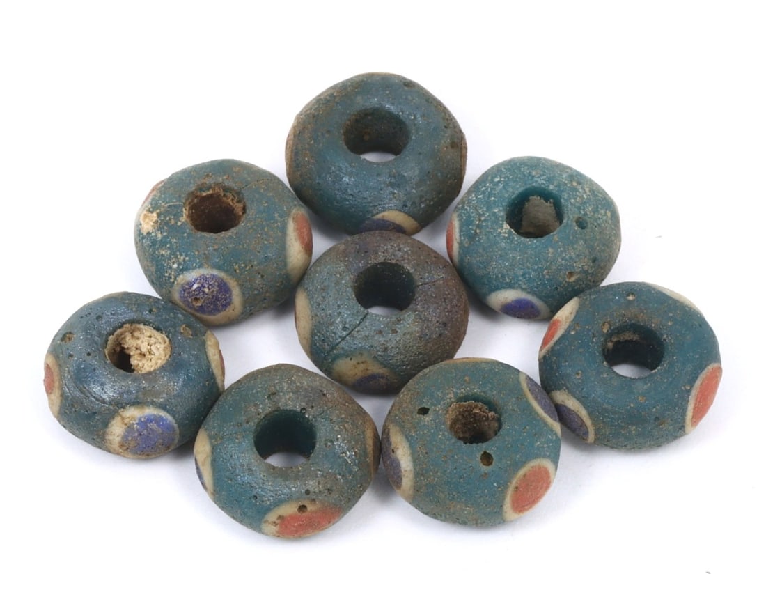 Collection of Antique Byzantine Wound Glass Beads, c. 6th-9th Century: This exquisite collection of bowl-shaped beads, made from celadon, teal, and cobalt wound glass with intricate mosaic glass insets, dates back to the Byzantine period (c. 6th-9th Century). It exemplif