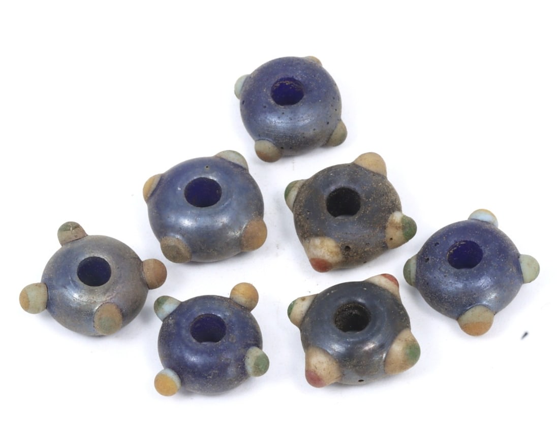 Lot of Antique Byzantine Wound Glass Collection of Beads, c. 500-800 AD: This exquisite collection of square cylinder-shaped beads, made from caviar, cobalt, and purple wound glass with mosaic glass insets. Dating back to the Byzantine Period (c. 500-800 AD), it exemplifie