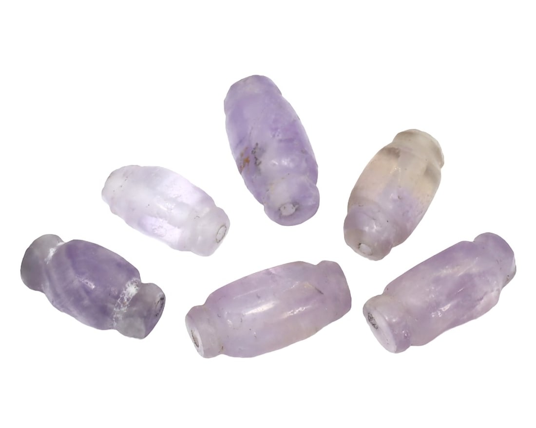 Lot of Antique Mughal Empire Amethyst Beads, c. 1526-1857: This collection of beads, made from purple, cobalt, and celadon amethyst. Dating back to the Mughal Empire (c. 1526-1857), it exemplifies the exquisite craftsmanship and intricate artistry characteris