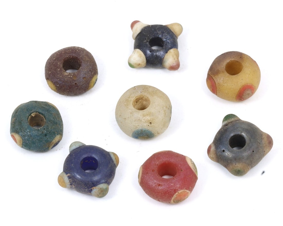 An Antique Late Byzantine Wound Glass Collection of Beads, c. 900-1453: This collection of beads, made from caviar, warming peach, and celadon wound glass with mosaic glass insets. Dating back to the Late Byzantine period (c. 900-1453), it exemplifies the exquisite crafts