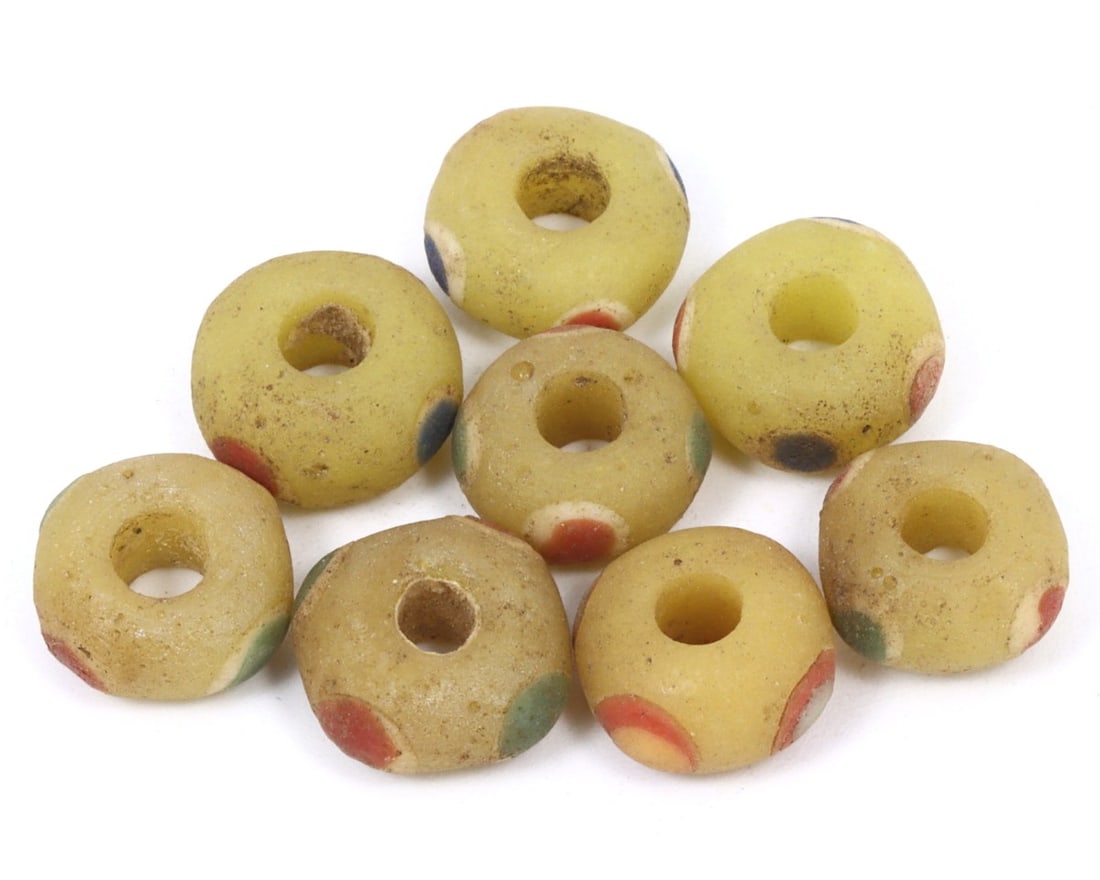 An Antique Byzantine Wound Glass Collection of Beads, c. 500-1453 AD: This exquisite collection of beads, made from warming peach, olive, and tan wound glass with mosaic glass insets. Dating back to the Byzantine period (c. 500-1453 AD), it exemplifies the intricate cra