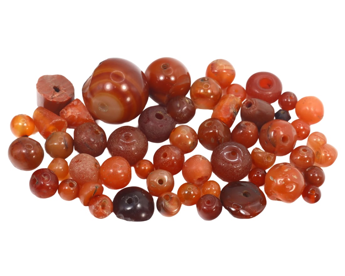 An Antique Late Neolithic Carnelian Collection of Beads, c. 3000-1500 BCE: This exquisite collection of mixed-shaped beads, made from caramelized, orange, and red carnelian. Dating back to the Late Neolithic period (c. 3000-1500 BCE), it exemplifies the intricate craftsmansh