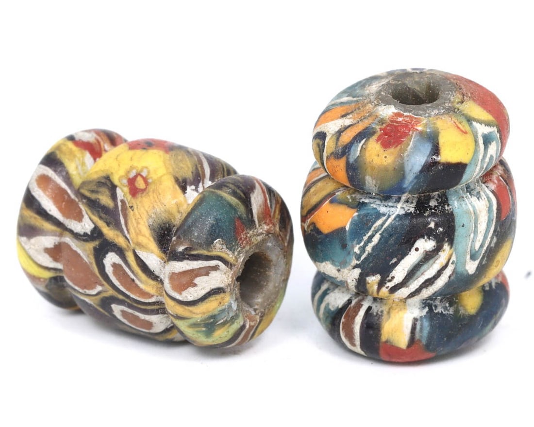 Pair of Antique Venetian Renaissance Mosaic Glass Beads, c. 1500-1600: This exquisite pair of beads, made from warming peach, caramelized, and marigold mosaic glass, dates back to the Venetian Renaissance period (c. 1500-1600). These mixed-shaped beads exemplify the intr