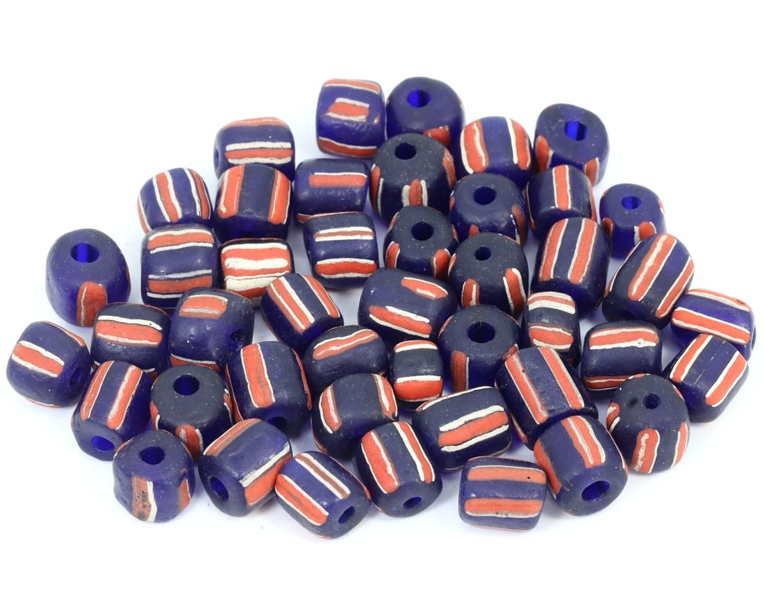 Lot of Vintage Renaissance Trailed, Wound Glass Collection of Beads, c. 1500-1600: This collection of beads, made from orange, purple, and cobalt trailed, wound glass, dates back to the Renaissance period (c. 1500-1600). It exemplifies the exquisite craftsmanship and intricate glass