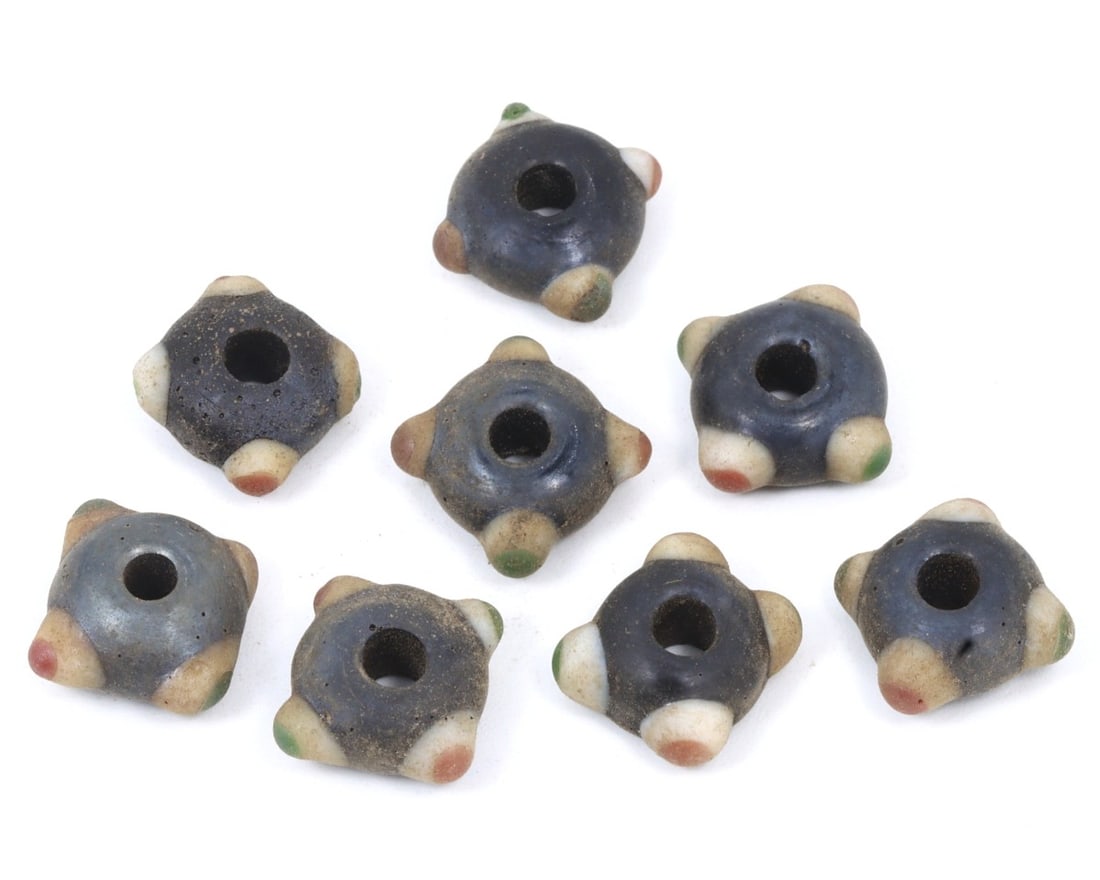 Lot of Antique Byzantine Wound Glass Collection of Beads, c. 500-900 AD: This collection of mixed-shaped beads, made from olive, caviar, and celadon wound glass with mosaic glass insets. Dating back to the Byzantine period (c. 500-900 AD), it exemplifies the intricate craf