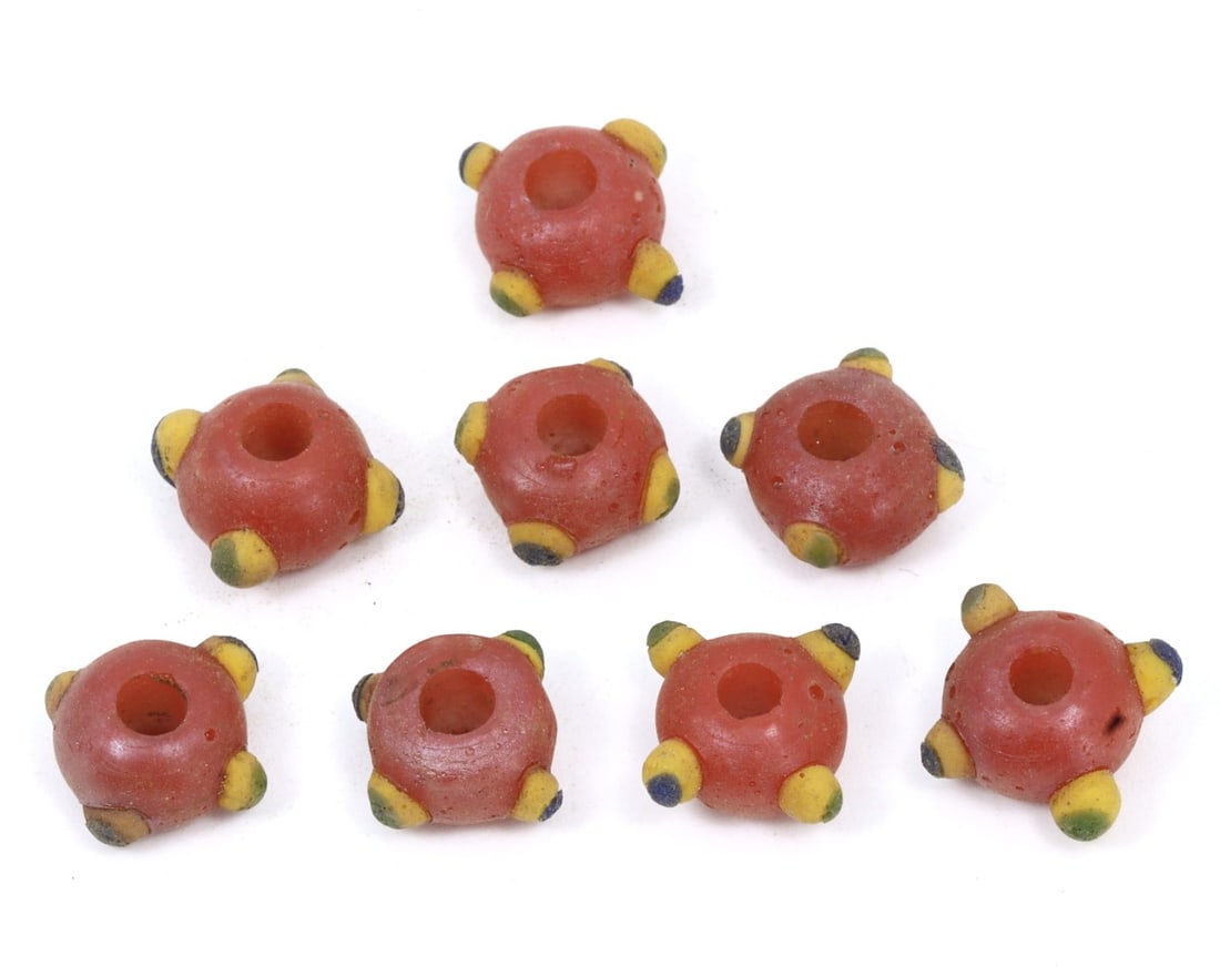 An Antique Byzantine Wound Glass Collection of Beads, c. 500-700 AD: This exquisite collection of platter-shaped beads, made from caviar, warming peach, and caramelized wound glass with mosaic glass insets. Dating back to the Byzantine Period (c. 500-700 AD), it exempl