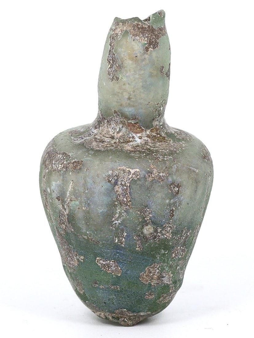 An Ancient Roman/Byzantine Glass Vessel, Circa 4th-6th Century CE: A compelling piece of antiquity, this glass vessel, sized at approximately 1.77 by 0.98 inches (4.5 x 2.5 cm), is a genuine relic from either the late Roman or early Byzantine period, specifically aro