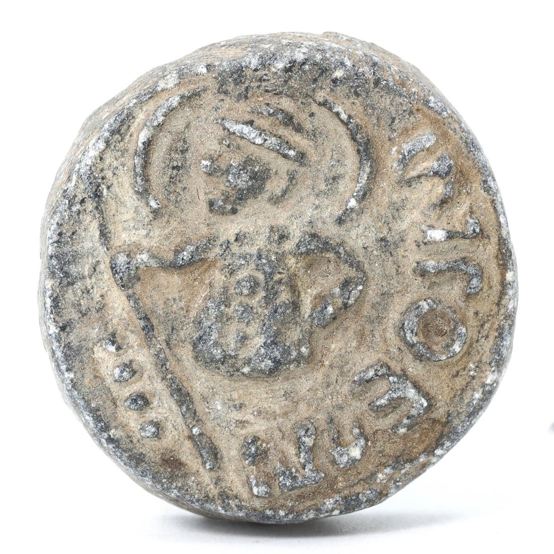 Ancient Byzantine Granite Coin-Form Seal with Inscribed Iconography, ca. 4th-7th Century AD: This granite seal, reminiscent of a coin, features intricately inscribed iconography, possibly denoting rank or affiliation in Byzantine society. The reverse's flatness suggests it was used to imprint