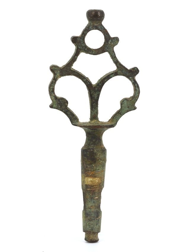 A Medieval Islamic Antique Bronze Key or Stopper, Circa 8th-10th Century: This object, with dimensions of 7.7 x 3 cm, appears to be a medieval Islamic bronze key or stopper, most likely from the 8th to 10th century. Its decorative top features a symmetrical openwork design