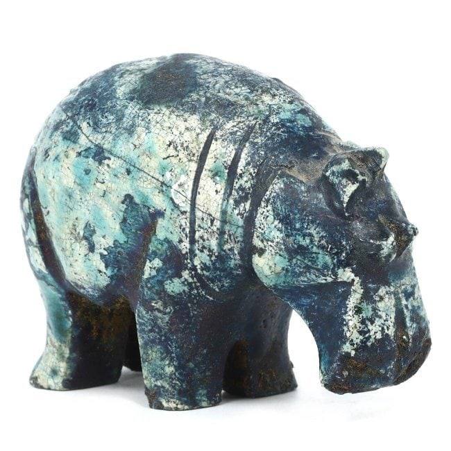 An Egyptian Glazed Steatite Hippopotamus, Late Period/Revival: This vibrant glazed steatite figurine, measuring 7 x 5 cm, depicts a hippopotamus, an animal that held significant meaning in ancient Egyptian culture, symbolizing both chaos and fertility. Whether an
