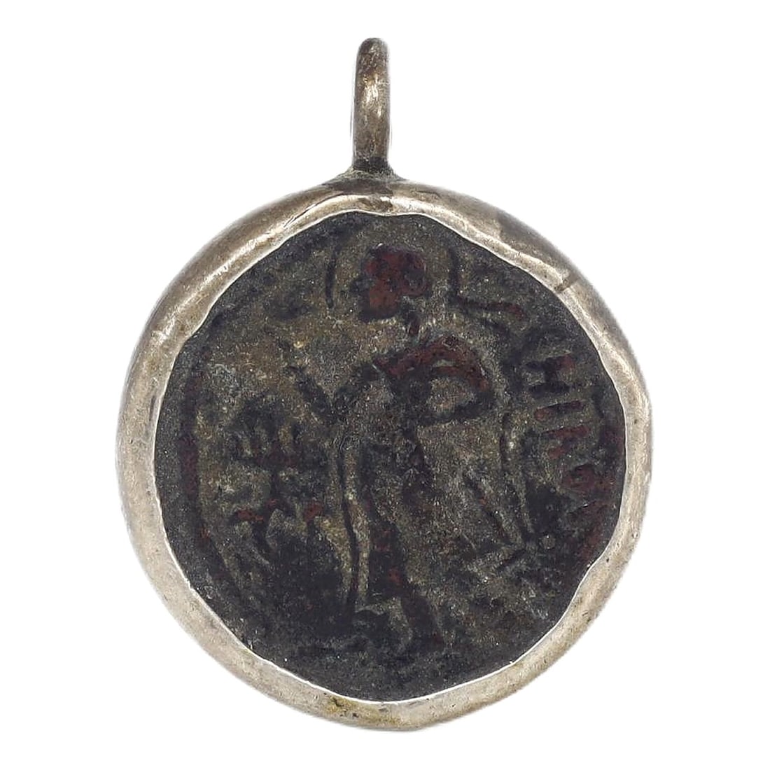An Ancient Byzantine Bronze Coin Set in Silver, c. 5th-7th Century CE: This authentic ancient bronze coin, set in silver, dates back to the Byzantine period, circa 5th to 7th century CE. The coin features a detailed figure and inscriptions characteristic of Byzantine art