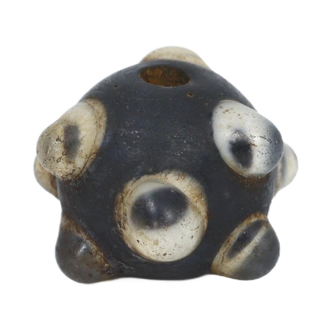An Ancient 'Evil Eye' Glass Bead, Byzantine Period, c. 330-1453 CE: This glass bead with its protruding 'evil eye' designs is a distinctive artifact from the Byzantine Period, echoing a widespread belief in the power of amulets to protect against malevolent gazes. The