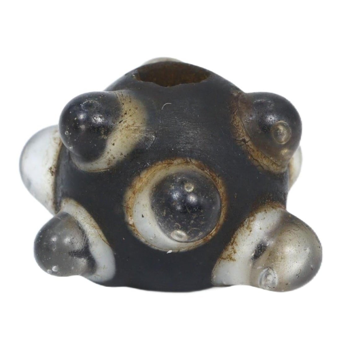 An Ancient 'Evil Eye' Glass Bead, Byzantine Period, c. 330-1453 CE: This glass bead with its protruding 'evil eye' designs is a distinctive artifact from the Byzantine Period, echoing a widespread belief in the power of amulets to protect against malevolent gazes. The