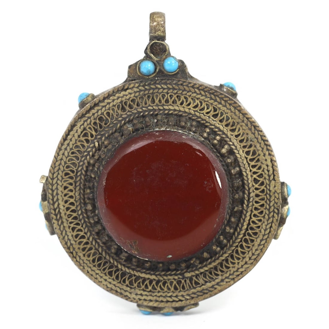 An Antique Islamic Carnelian, Turquoise, and Silver Amulet Locket, c. 18th - 19th Century: This amulet locket features a striking red gemstone at the center, made from carnelian, turquoise, and silver. Dating back to the c. 18th - 19th Century, it exemplifies the exquisite craftsmanship and
