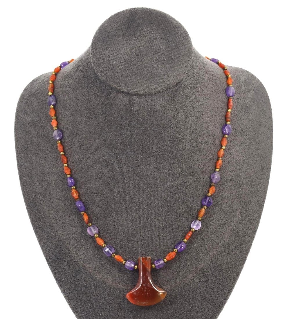 An Antique Mughal Empire Amethyst and Carnelian Necklace with Locket, 17th Century: This exquisite necklace features amethyst and carnelian beads with a central locket, typical of the 17th-century Mughal craftsmanship. The combination of amethyst for spirituality and carnelian for pr